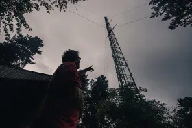 A scientist pointing at the ICOS Saclay Atmosphere station in France.