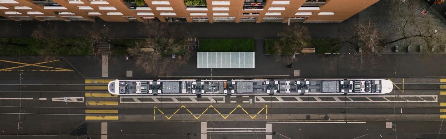Top-down view of tram stopped along city street