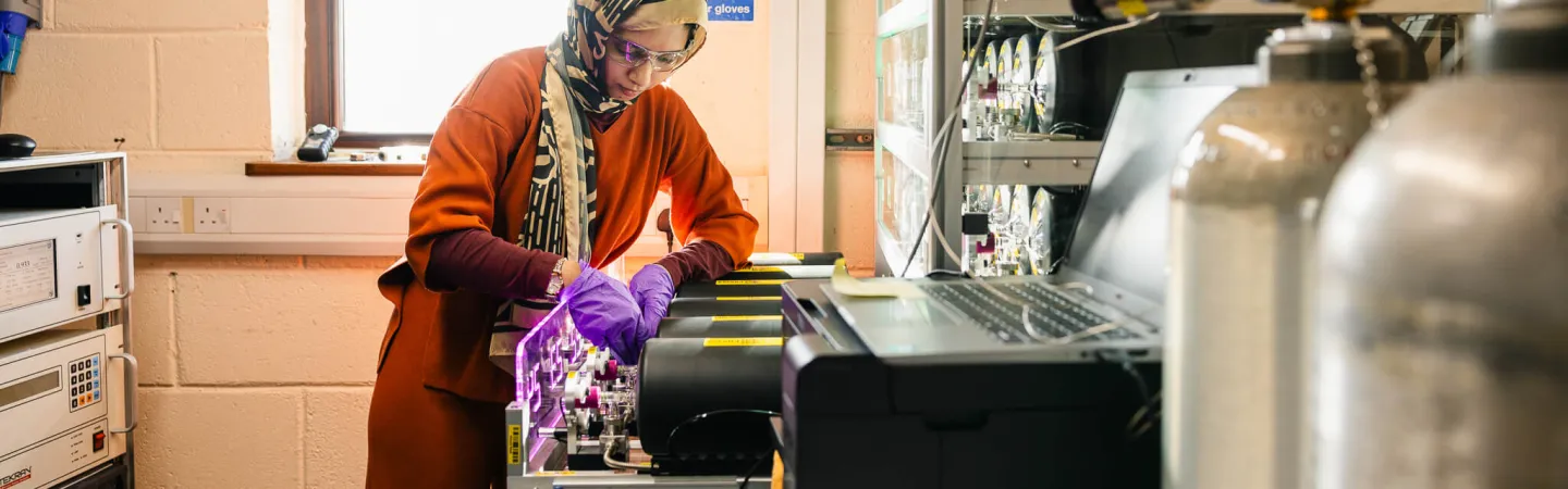 Scientist adjusting analytical equipment in a laboratory