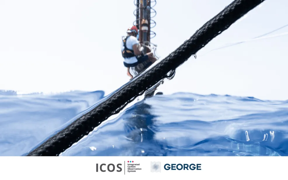 photo of seawater surface with a man working on a measurement tower on the background